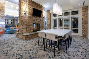 a living room with a table and a fireplace at Hilton Garden Inn Roanoke in Roanoke