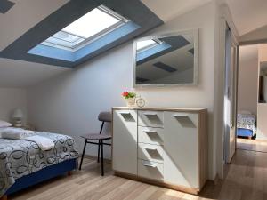 a bedroom with a bed and a skylight at Apartmans and Rooms Madunic M in Split