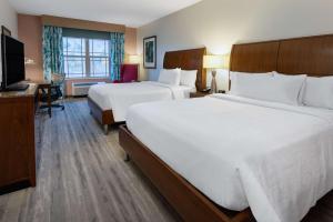 a hotel room with two beds and a television at Hilton Garden Inn Roanoke in Roanoke