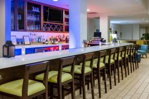 a bar with a row of chairs in a restaurant at Hilton Garden Inn Roanoke in Roanoke