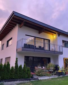 a large white house with a balcony at Haus "Charly" in Nauders
