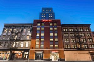 a building with a red sign on top of it at Hampton Inn San Francisco Downtown/Convention Center in San Francisco