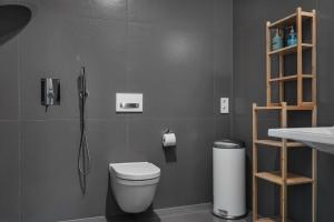 a bathroom with a shower and a toilet and a sink at Style Meets Location in Göteborg in Gothenburg