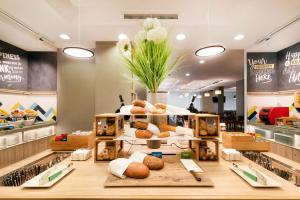 a bakery with a display of breads and pastries at Hampton by Hilton Krakow in Krakow