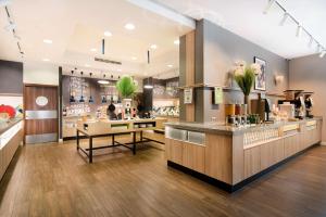 a restaurant with a kitchen with a counter at Hampton by Hilton Krakow in Krakow