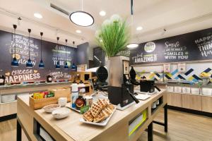 a fast food restaurant with a counter with food at Hampton by Hilton Krakow in Krakow