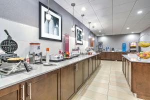 a cafeteria with a long counter in a pharmacy at Hampton Inn Macon - I-475 in Macon