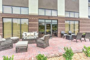 a patio with chairs and tables in front of a building at Hampton Inn Macon - I-475 in Macon
