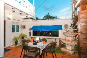 a patio with a table and chairs and a fireplace at Luxury My Villa Bentota 200m Bentota Beach in Bentota
