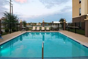 a swimming pool with blue water in a building at Hampton Inn and Suites Hutto in Hutto