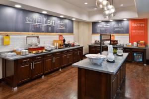 a restaurant kitchen with a counter top and a food court at Hampton Inn and Suites Hutto in Hutto