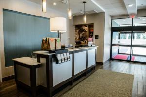 a lobby of a store with a counter with a lamp at Hampton Inn Bainbridge, GA in Bainbridge