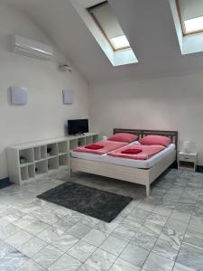 um quarto com uma cama com almofadas vermelhas em Penzion pod lesem em Most