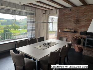 a dining room with a table and chairs at WinterbergerQuartier in Winterberg