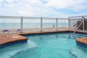 a swimming pool with a view of the beach at Hilton Garden Inn Daytona Beach Oceanfront in Daytona Beach