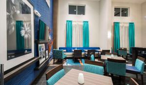 un comedor con mesas y sillas azules en Hampton Inn & Suites Orlando near SeaWorld en Orlando