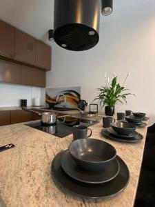 a kitchen counter with bowls and plates on it at Apartament JB 56m2 parking,balkon,2sypialnie in Legnica