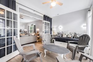 a living room with a couch and a table and chairs at Bethany Breeze --- 38424 Driftwood Ct #629 in Frankford