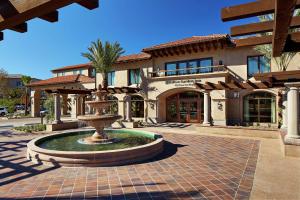 a building with a fountain in front of a building at Hilton Garden Inn San Diego Old Town/Sea World Area in San Diego