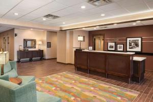 a lobby with a waiting room with a reception desk at Hampton Inn Lincoln Airport, Ne in Lincoln