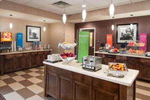a lobby with a breakfast counter with fruit on it at Hampton Inn Lincoln Airport, Ne in Lincoln