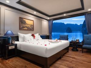 a bedroom with a large bed and a large window at Doris Cruise in Ha Long