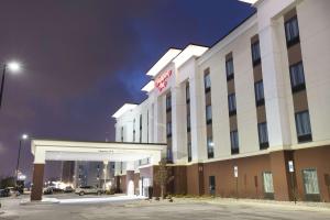 a hotel exterior at night with a parking lot at Hampton Inn & Suites - Toledo/Oregon in Oregon
