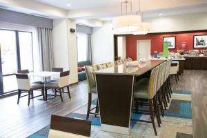 a dining room and kitchen with a table and chairs at Hampton Inn & Suites - Toledo/Oregon in Oregon