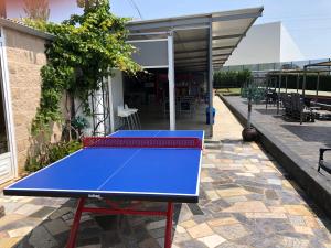 a blue ping pong table on a patio at La Villa del Karting in El Teso