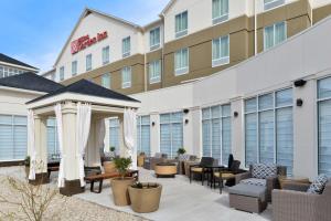 a hotel patio with chairs and a gazebo at Hilton Garden Inn Hobbs in Hobbs