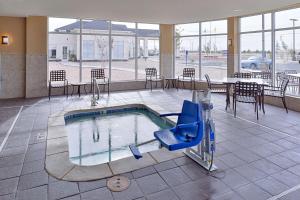 a swimming pool with a slide in a building at Hilton Garden Inn Hobbs in Hobbs