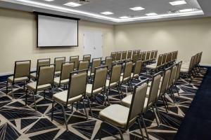 a conference room with chairs and a screen at Homewood Suites by Hilton Richmond-Downtown in Richmond