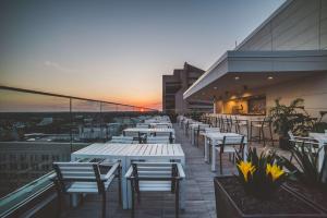 a row of tables and chairs on the roof of a building at Homewood Suites by Hilton Richmond-Downtown in Richmond