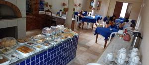 a buffet in a restaurant with bread and pastries at Pousada Tartaruga Cumbuco in Cumbuco