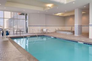 a large swimming pool in a hotel room at Embassy Suites by Hilton Kansas City Olathe in Olathe