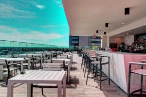 a row of tables and chairs on the roof of a building at Hampton Inn & Suites - Richmond - Downtown, VA in Richmond