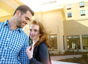 a man and a woman standing in front of a building at Longview Hilton Garden Inn in Longview