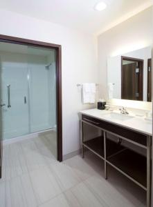 a bathroom with a sink and a glass shower at Homewood Suites by Hilton Houston/Katy Mills Mall in Katy