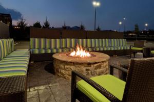 a fire pit with couches and chairs in front of it at Home2 Suites by Hilton Atlanta South/McDonough in McDonough