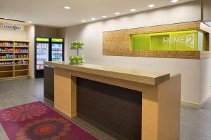 a lobby of a home store with a fireplace at Home2 Suites by Hilton Atlanta South/McDonough in McDonough