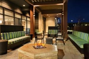 a patio with two couches and a fire pit at Home2 Suites by Hilton Milton Ontario in Milton