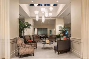 a lobby with a waiting room with chairs and a table at Homewood Suites by Hilton Miami Dolphin Mall in Miami