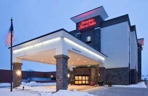 a building with a sign on it in the snow at Hampton Inn & Suites Sioux City South, IA in Sioux City