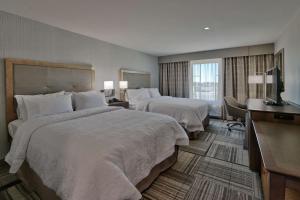 a hotel room with two beds and a television at Hampton Inn & Suites Artesia in Artesia +24 photos