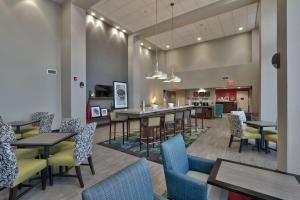 a restaurant with tables and chairs and a bar at Hampton Inn & Suites Las Cruces I-10, Nm in Las Cruces