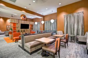 a living room with a couch and a tv at Homewood Suites by Hilton Nashville Franklin in Franklin