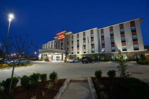 a hotel building with a parking lot at night at Hampton Inn & Suites Stillwater West in Stillwater