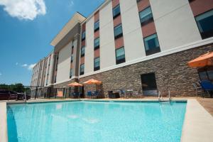 a large swimming pool in front of a hotel at Hampton Inn & Suites Stillwater West in Stillwater