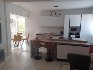 a kitchen with a island with stools in it at Kuca za odmor Damir in Šmrika