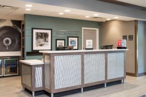 a waiting area in a store with a counter at Hampton Inn and Suites Michigan City in Michigan City